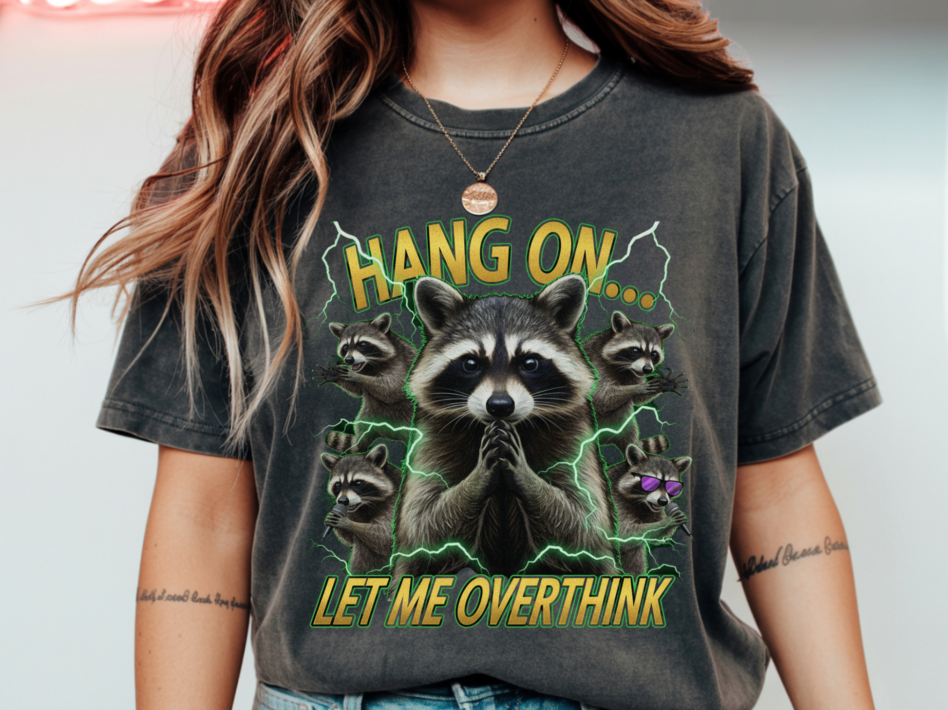 Person wearing a t-shirt with raccoon graphic and text 'Hang on... let me overthink'.